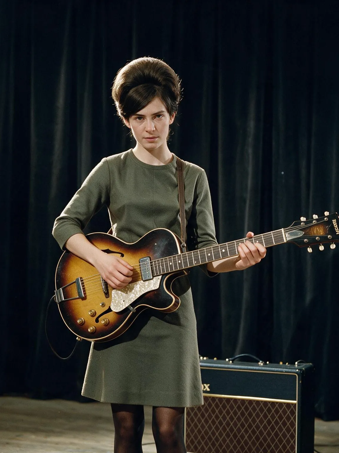 Grace Ticehurst playing a sunburst archtop guitar on stage
